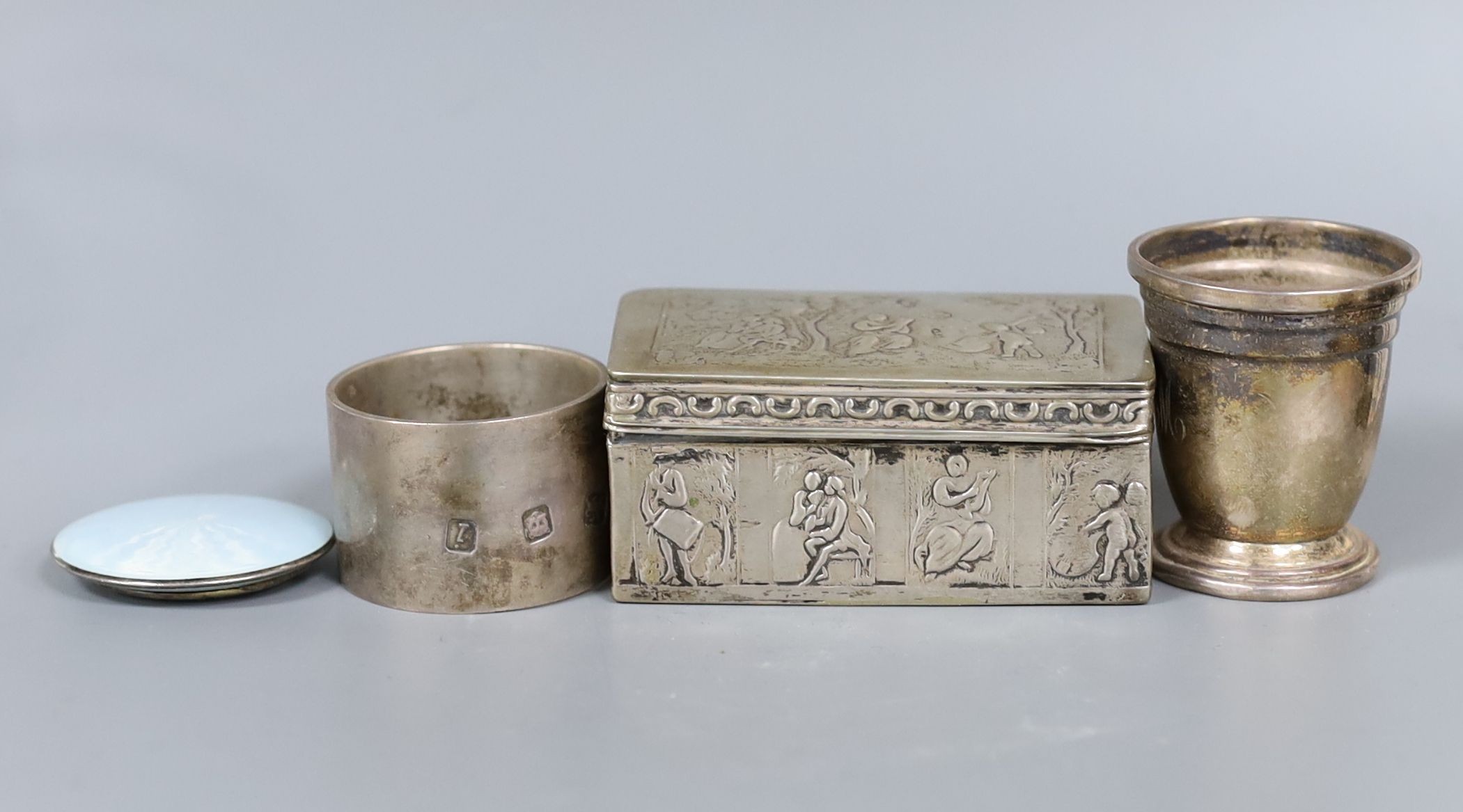 A late 19th century Dutch? white metal rectangular box and cover, 83mm, a small silver cup, a silver napkin ring and a silver and enamel small circular compact.